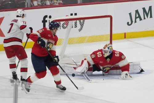 Florida Panthers goaltender Chris Driedger (60) stops a shot by Carolina Hurricanes forward Skyler Brind'Amour (77) during the second period of a preseason NHL hockey game, Saturday, Sept. 28, 2024, in Sunrise, Fla. (AP Photo/Marta Lavandier)