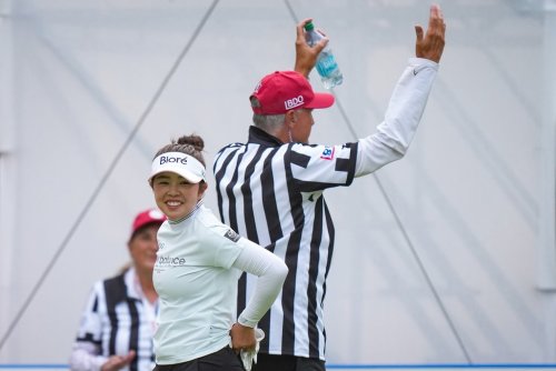 Miyu Yamashita, of Japan, laughs as she walks past a volunteer dressed as a hockey referee on the 17th tee during the third round at the LPGA CPKC Canadian Women's Open golf tournament, in Edmonton, on Saturday, Aug. 22, 2026. THE CANADIAN PRESS/Darryl Dyck