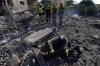 Rescue workers search for victims under the rubble of a building destroyed in an Israeli airstrike in the southern village of Kfar Rumman, Lebanon, Monday, Sept. 7, 2026. (AP Photo/Mohammed Zaatari)