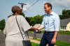 Democratic candidate for Connecticut's First Congressional District Luke Bronin, left, speaks with a potential voter outside of Rawson School in Hartford, Conn. on Tuesday, Aug. 11, 2026. Bronin faces incumbent Congressman John Larson in the primary.(AP Photo/Rusty Jones)