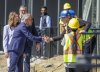 Prime Minister Mark Carney, centre, and Alberta Premier Danielle Smith shakes hands with construction workers while making a housing announcement in Red Deer, Alta., Wednesday, July 29, 2026. THE CANADIAN PRESS/Jeff McIntosh