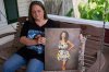 Christy Spivey poses with a portrait of her late daughter Tasia Fortune, Tuesday, Sept. 8, 2026, in Marion, Ky. (AP Photo/George Walker IV)