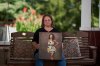 Christy Spivey poses with a portrait of her late daughter, Tasia Fortune, on Tuesday, Sept. 8, 2026, in Marion, Ky. (AP Photo/George Walker IV)