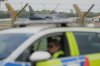 A B1 bomber prepares to take off as police officers man a checkpoint near RAF Fairford air base, in Fairford, England Tuesday, Sept. 29, 2026. (AP Photo/Alastair Grant)