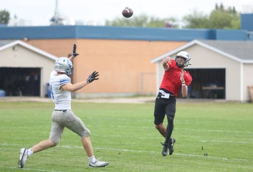 Vincent Massey Vikings quarterback Charlie Gauthier throws the ball with pressure in his face during a preseason game against the Oak Park Raiders at Vincent Massey High School on Thursday. (Rowan McCarthy/The Brandon Sun)