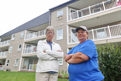 Spruce Woods Housing Co-operative board president Noreen Mitchell (left) stands with property manager Eva Cameron on Friday morning outside the housing complex on Braecrest Drive in Brandon. (Matt Goerzen/The Brandon Sun)