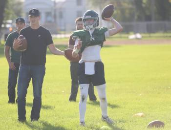 Jacob Doerksen (left), works with quarterback Sean Kelly (right) at Neelin Trojans practice on Wednesday at Neelin High school. This is Doerksen;s first full season as a head coach. (Rowan McCarthy/The Brandon Sun) Sept. 9, 2026.