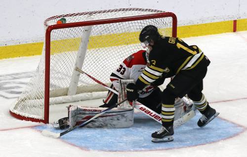 Brandon Wheat Kings forward Colin Grubb (13) tucks the puck behind Moose Jaw Warriors goaltender Kyle Jones (33) during Western Hockey League action at Assiniboine Credit Union Place on Friday. (Photos by Perry Bergson/The Brandon Sun)