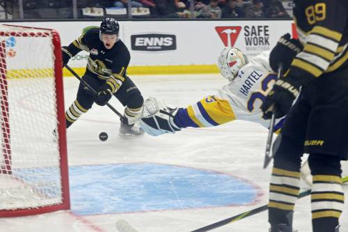 Brandon Wheat Kings forward Chase Surkan fires the puck past goalie Max Hartel of the Saskatoon Blades for a goal during the season home opener at Assiniboine Credit Union Place on Friday evening. (Tim Smith/The Brandon Sun)