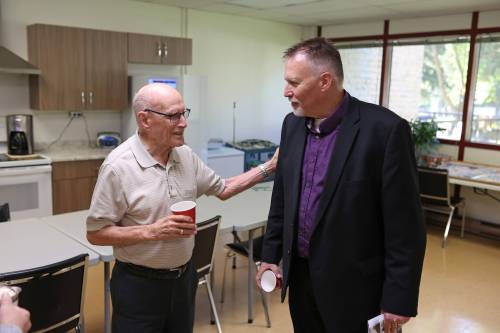 Brandon mayoral candidate Len Isleifson (right) speaks with Hobbs Manor resident Roy Walwyn after giving a presentation to residents on Thursday morning. (Tim Smith/The Brandon Sun)