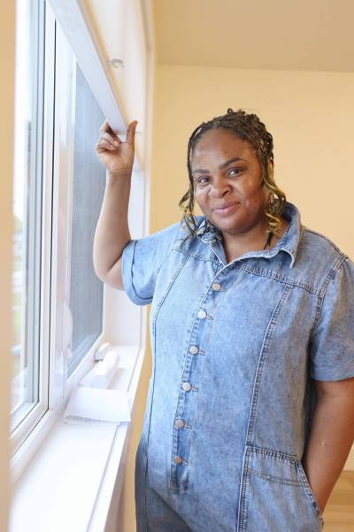 Zeenat Oyetunjai lets natural light into the upstairs living room of her home in Brandon. Oyetunjai was selected by Habitat for Humanity for its affordable homeownership program. (Rylee Gerrard/The Brandon Sun)