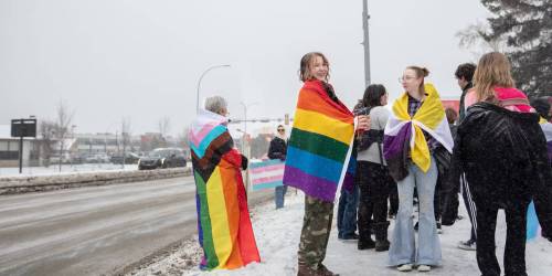 Students walk out of a high school to protest sweeping gender policies announced by the UCP in Leduc, Alta., in February 2024. (The Canadian Press files)