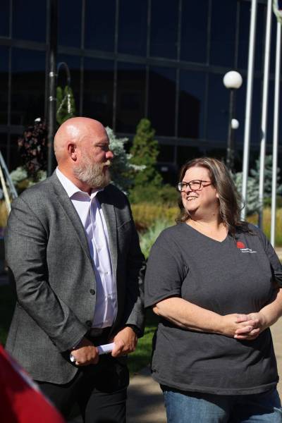 Tyson Tame, campaign chair, and Cynamon Mychasiw, chief executive officer of United Way West Central Manitoba, chat after the flag-raising ceremony at Brandon City Hall on Monday to announce the fundraising goal for the 2026 