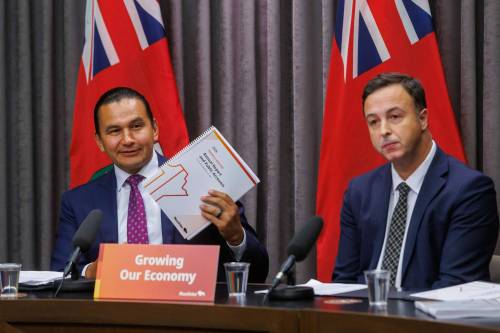 Premier Wab Kinew (left) and Finance Minister Adrien Sala announce that the province is on track to balance the budget next year after cutting the deficit in half since the third-quarter update during a press conference on Monday. (Mike Deal/Winnipeg Free Press)
