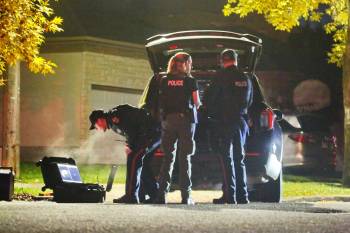 A Brandon police officer monitors video equipment showing a feed from a police drone operating overhead on Whillier Drive late Thursday evening. Police were staked out on Whillier during a standoff with a suspect who was believed to be holed up in a residence one street over on Creighton Boulevard. (Photos by Matt Goerzen/The Brandon Sun)