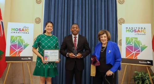 Labour and Immigration Minister Malaya Marcelino (left) and Manitoba Lt.-Gov. Anita Neville (right) join Aloysius Anyichie with his 2026 Manitoba Mosaic Award in the Welcoming Community Champion–Individual category plaque during the award ceremony at the Manitoba Legislative Building in Winnipeg. (Supplied)
