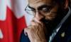 Obby Khan fights back tears as he announces his resignation as leader and member of the Manitoba Progressive Conservative party in his legislature office in Winnipeg on Monday.