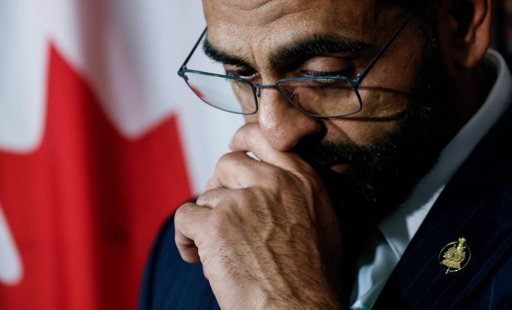 Obby Khan fights back tears as he announces his resignation as leader and member of the Manitoba Progressive Conservative party in his legislature office in Winnipeg on Monday.