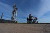 David Orr rides his bike past SpaceX's mega rocket Starship as it is prepared for a test flight from Starbase, Texas, Sunday, Sept. 27, 2026. (AP Photo/Eric Gay)