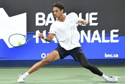 Gabriel Diallo of Canada slides for the ball during his second-round match against Luciano Darderi of Italy at the National Bank Open tennis tournament in Montreal on Aug. 4, 2026. THE CANADIAN PRESS/Graham Hughes