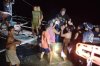 In this image provided by the Philippine Coast Guard, a survivor is assisted as he alights from a small boat after being rescued from a burning ferry off Palawan province, Philippines on Wednesday Sept. 9, 2026. (Philippine Coast Guard via AP)