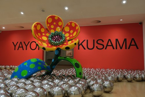 Flowers and reflective balls are seen at a major retrospective of works by recently deceased Japanese artist Yayoi Kusama at the Stedelijk Museum in Amsterdam, Wednesday, Sept. 9, 2026. (AP Photo/Mike Corder)