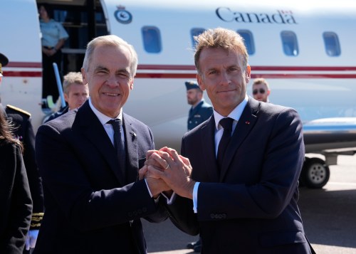 French President Emmanuel Macron, right, greets Prime Minister Mark Carney as he arrives in Saint-Pierre, Saint-Pierre-et-Miquelon, a French territory 20 kilometres off the southern coast of Newfoundland, on Sunday, Sept. 20, 2026. THE CANADIAN PRESS/Adrian Wyld