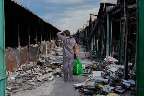 FILE - A woman reacts to charred books after a fire at the country's biggest book market, caused by a Russian missile attack in Kyiv, Ukraine, Aug. 19, 2026. (AP Photo/Efrem Lukatsky, File)