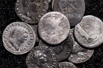 Roman coins, including the one coin, centre, dating from 148 B.C., when Rome was still a republic without an emperor, are on display at the LVR State Museum, in Bonn, Germany, Tuesday Sept. 22, 2026. (Rolf Vennenbernd/dpa via AP)