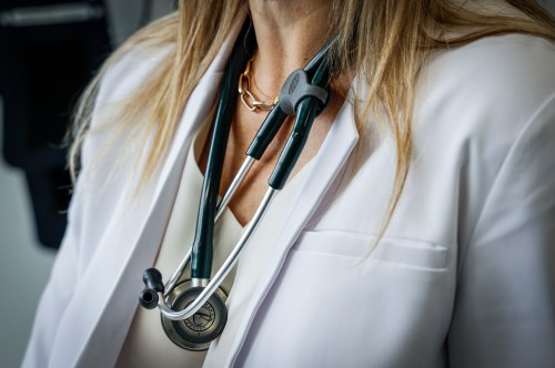 A doctor wears a lab coat and stethoscope in an exam room at a health clinic in Calgary, Friday, July 14, 2023. THE CANADIAN PRESS/Jeff McIntosh