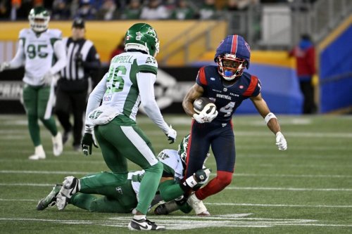 Montreal Alouettes' Charleston Rambo (14) gets taken down by Saskatchewan Roughriders' Antoine Brooks Jr. (33) during second half CFL football action at the 112th Grey Cup, in Winnipeg on Sunday, Nov. 16, 2025. THE CANADIAN PRESS/Fred Greenslade