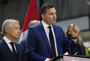 Minister of Artificial Intelligence and Digital Innovation Evan Solomon speaks as Minister of Finance and National Revenue Francois-Philippe Champagne looks on during a news conference in Ottawa on Tuesday, Aug. 25, 2026. THE CANADIAN PRESS/Justin Tang