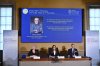 A portrait of Francis Halzen is shown on the screen as Eva Olsson, Ellen Moons, and Mark Pearce announce as the recipient of the 2026 Nobel Prize in Physics during a press conference at the Royal Swedish Academy of Sciences, Stockholm, Sweden, Oct. 6, 2026. (Christine Olsson/TT News Agency via AP)