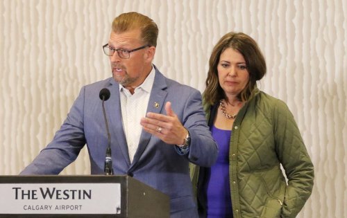 Alberta Minister of Public Safety and Emergency Services Mike Ellis answers media questions as Alberta Premier Danielle Smith looks on at an availability in Calgary on August 25, 2023. THE CANADIAN PRESS/Dave Chidley