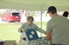 Brandon University Student Services staff member Joan Garbutt gives a new student a slice of pizza during fall orientation on Tuesday afternoon. (Abiola Odutola/The Brandon Sun)