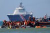 FILE - A group of migrants try to cross the channel from France to Britain on a dinghy boat, in Hardelot, northern France, Wednesday, Sept. 23, 2026. (AP Photo/Jean-Francois Badias, File)