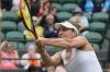 Gabriela Dabrowski of Canada plays return to Caroline Dolehide of the United States and Desirae Krawczyk of the United States during their semifinal doubles match at the Wimbledon tennis championships in London, Friday, July 12, 2024. Dabrowski's playing partner is Erin Routliffe of New Zealand . (AP Photo/Alastair Grant)