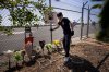 A person adjusts flowers at a memorial for Eliana Moreno and George Marciniw who died in a helicopter crash at the site where their helicopter used to park at Whiteman Airport in Los Angeles, Wednesday, Sept. 16, 2026. (AP Photo/Ethan Swope)