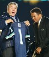 Former Canadian boxing champ George Chuvalo presents Muhammad Ali a Toronto Argonauts jersey at a Parkinson's Disease fundraiser during half time of the Toronto Argonauts vs Ottawa Renegades CFL matchup in Toronto on Sunday Oct. 20, 2002. THE CANADIAN PRESS/Frank Gunn