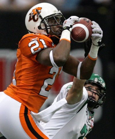 B.C. Lions' Ryan Phillips, left, intercepts a pass intended for Saskatchewan Roughriders' Weston Dressler during first half CFL action in Vancouver, B.C., on Friday October 2, 2009. THE CANADIAN PRESS/Darryl Dyck