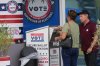 A person drops a vote-by-mail ballot in a secure ballot intake station at the Office of the Supervisor of Elections during early voting in the 2026 midterm elections, Tuesday, Oct. 27, 2026, in Doral, Fla. (AP Photo/Lynne Sladky)