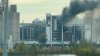 In this image from video, fire and smoke rise from a building attached to Quaker Oats facility in Cedar Rapids, Iowa. (Brian Owens via AP)