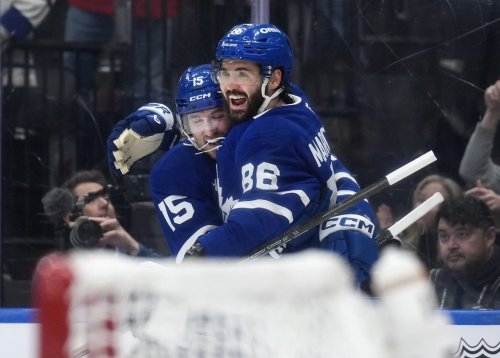 Toronto Maple Leafs' Kirill Marchenko (86) celebrates his hat trick goal against the Buffalo Sabres with Colton Sissons (15) during second period NHL hockey action in Toronto on Thursday, Oct. 15, 2026. THE CANADIAN PRESS/Nathan Denette