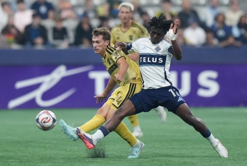 St. Louis City's Daniel Edelman (24) and Vancouver Whitecaps' Emmanuel Sabbi (11) vie for the ball during the first half of an MLS soccer match, in Vancouver, on Saturday, Sept. 5, 2026. THE CANADIAN PRESS/Darryl Dyck