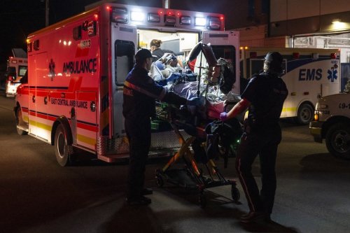 Paramedics load an injured person into an ambulance at the Wainwright Health Centre as injured military members are treated after a fire at CFB Wainwright, outside of Wainwright, Alta., on Saturday, Oct. 17, 2026. THE CANADIAN PRESS/John Ulan