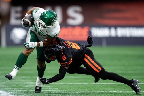 Saskatchewan Roughriders' Johnny Johnson III (88) is pushed out by BC Lions' TJ Lee (6) during the first half of a CFL football game in Vancouver on Sunday, Aug. 23, 2026. THE CANADIAN PRESS/Ethan Cairns