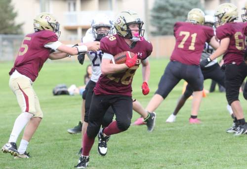 Crocus Plains running back Dustin Douglas turns up field on his way to scoring a touchdown while quarterback Jackson Penner blocks Max Shields of the Vincent Massey Vikings during the game at Vincent Massey on Tuesday. Douglas scored two touchdowns on offence and one on defence during the contest. (Rowan McCarthy/The Brandon Sun)