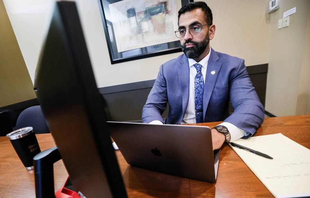 Obby Khan, former leader of the Manitoba PC party, works in his office in the legislature in Winnipeg on Tuesday. (John Woods/Winnipeg Free Press)