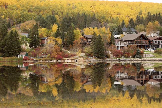 Vibrant fall colours are reflected in Minnedosa Lake on a calm Thursday morning. The recent mild weather is expected to continue until Saturday and then turn cooler, with Environment Canada forecasting a high of just 8 C on Sunday and 7 C on Thanksgiving Monday. (Tim Smith/The Brandon Sun)