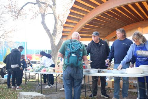 Brandon West MLA Wayne Balcaen, Brandon Mayor Jeff Fawcett and Spruce Woods MLA Colleen Robbins serve food to a city resident during the Global African Diaspora Network Mobilization's Thanksgiving lunch for people experiencing homelessness Saturday afternoon at Princess Park. (Abiola Odultola/The Brandon Sun)